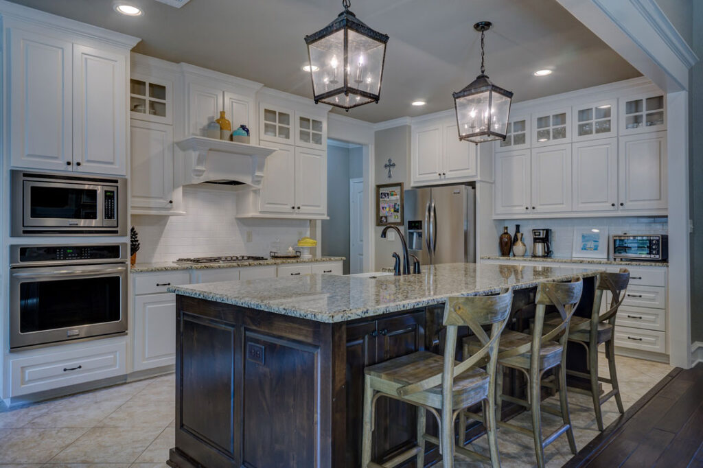 A residential kitchen with hanging and recessed lights.