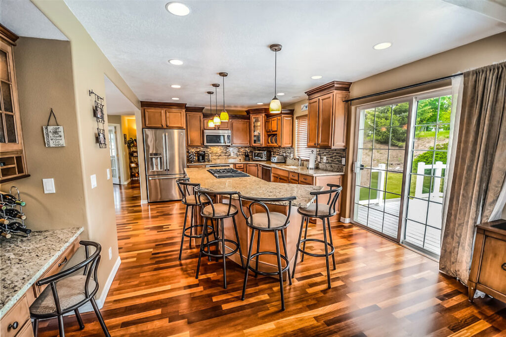 A residential kitchen with hanging and can lights.